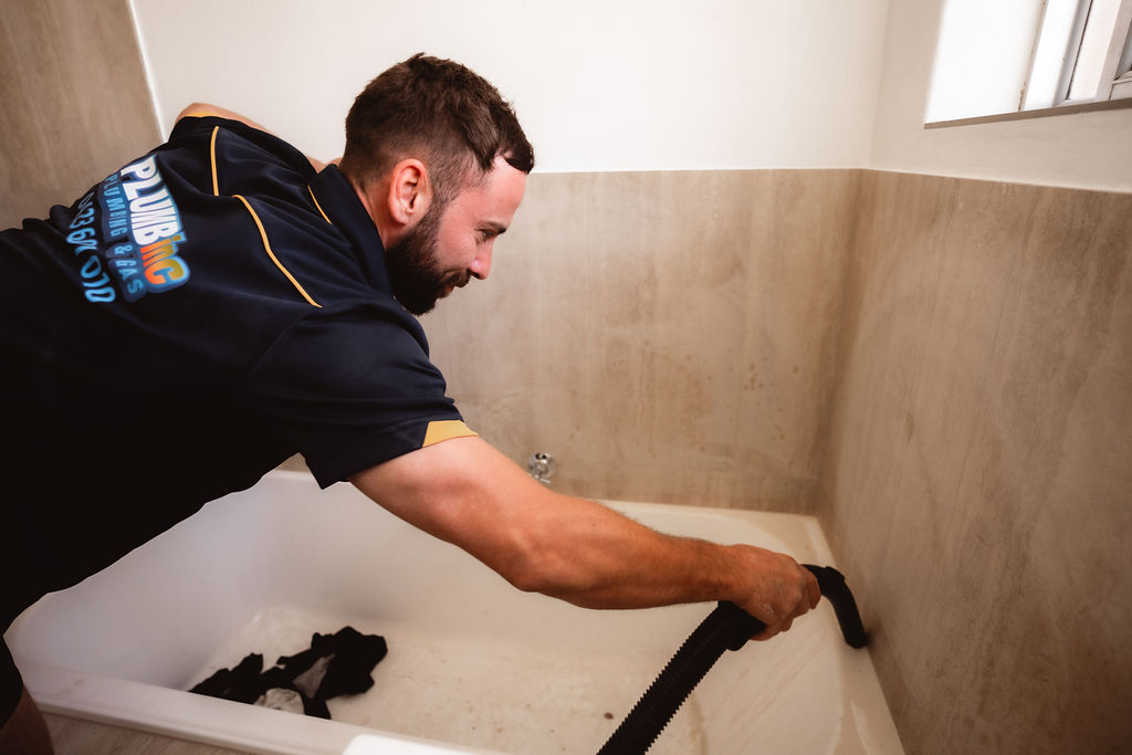 Plumber finishing the beading of a bathroom renovation