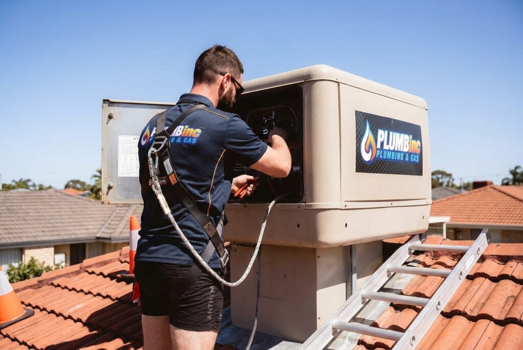 PlumbInc servicing an on roof evaporative air conditoner