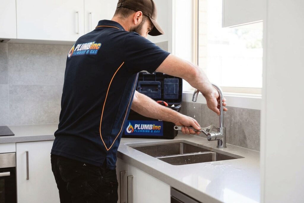 Dylan from PlumbInc reseating a washer for a leaking tap